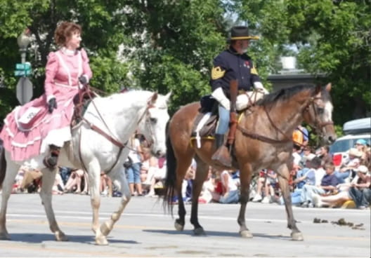 Two riders on horses in a parade