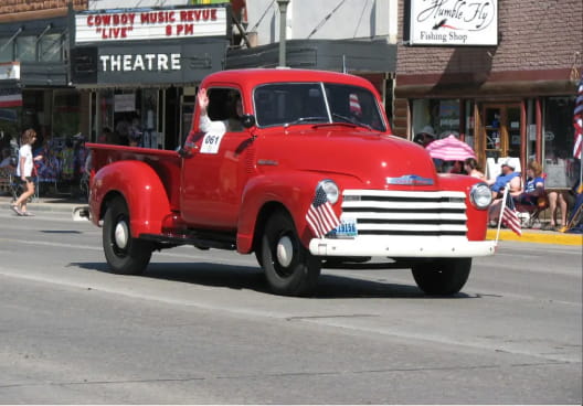 Vintage red pickup truck in a parade