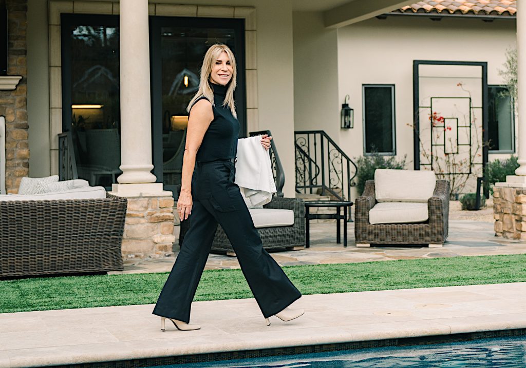 Silicon Valley REALTOR, Julie Wyss, strolling alongside a swimming pool.