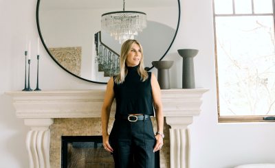 Julie Wyss, Silicon Valley REALTOR, standing in front of a grand fireplace.