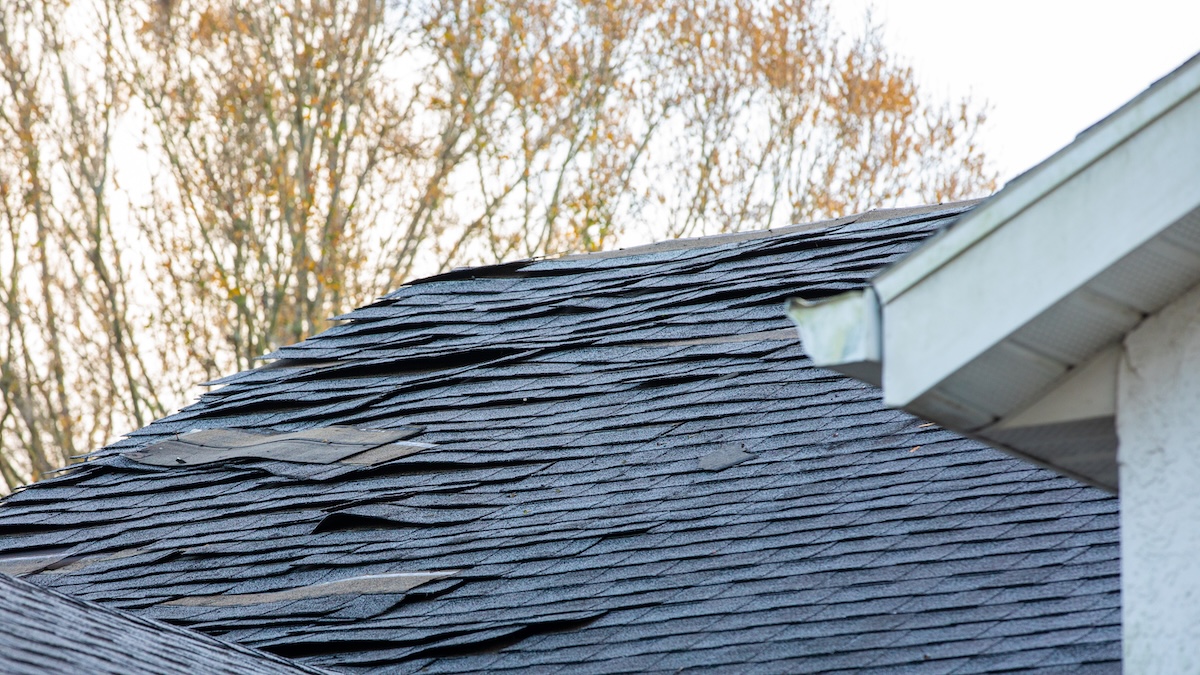 old roof shingle on the roof of house needs replacing