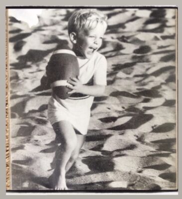 Young Andy Lyon playing on the beach in Malibu Colony, symbolizing his lifelong roots in the Malibu community.