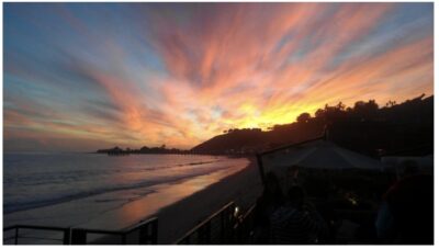 Aerial sunset view of Malibu’s coastline featured in the 4 Malibu Real Estate October 22, 2025 newsletter highlighting 18073 Sandy Cape Drive.