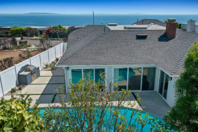 A view of 18133 Wakecrest Dr in Malibu, a single-story Sunset Mesa lease home with a private pool, patio, and ocean views toward Catalina Island.
