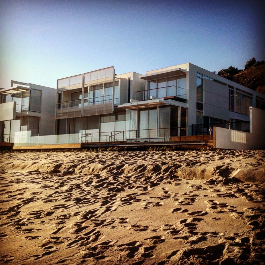Modern architectural luxury home directly on the sand along Carbon Beach in Malibu.
