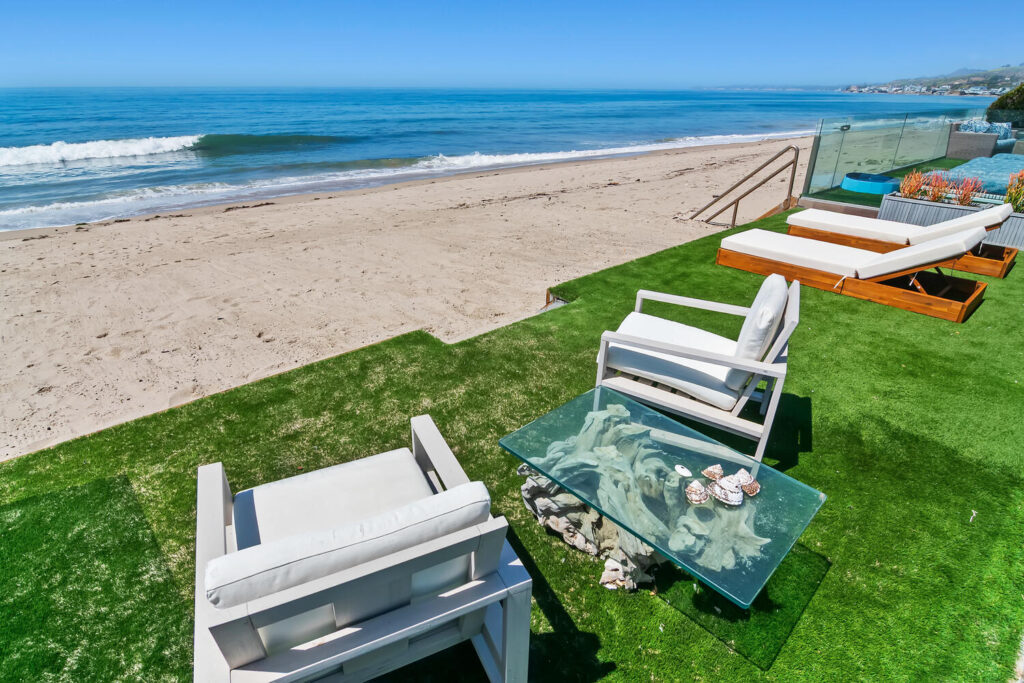 Oceanfront deck with lounge chairs overlooking the sandy beach in Malibu Colony
