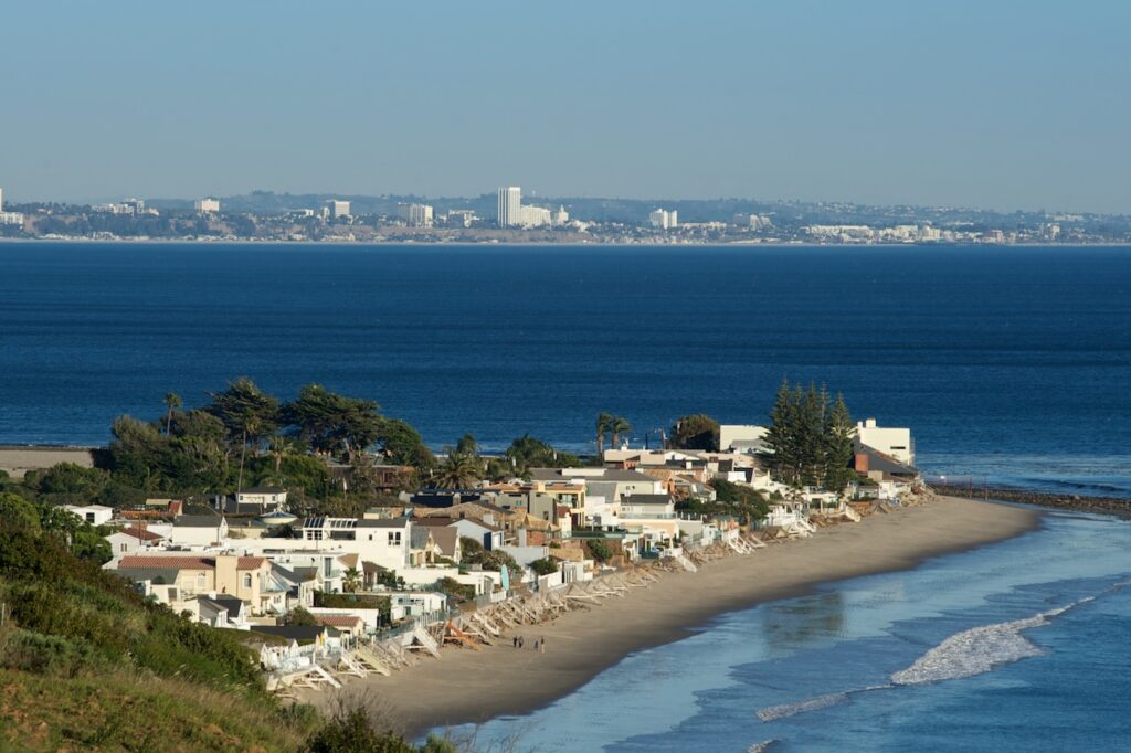 Aerial view of Malibu Colony and the surrounding Malibu coastline on a clear day.