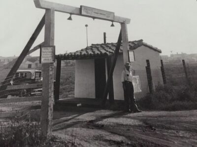 Historic black-and-white photo of the original Malibu Colony gate and entrance.