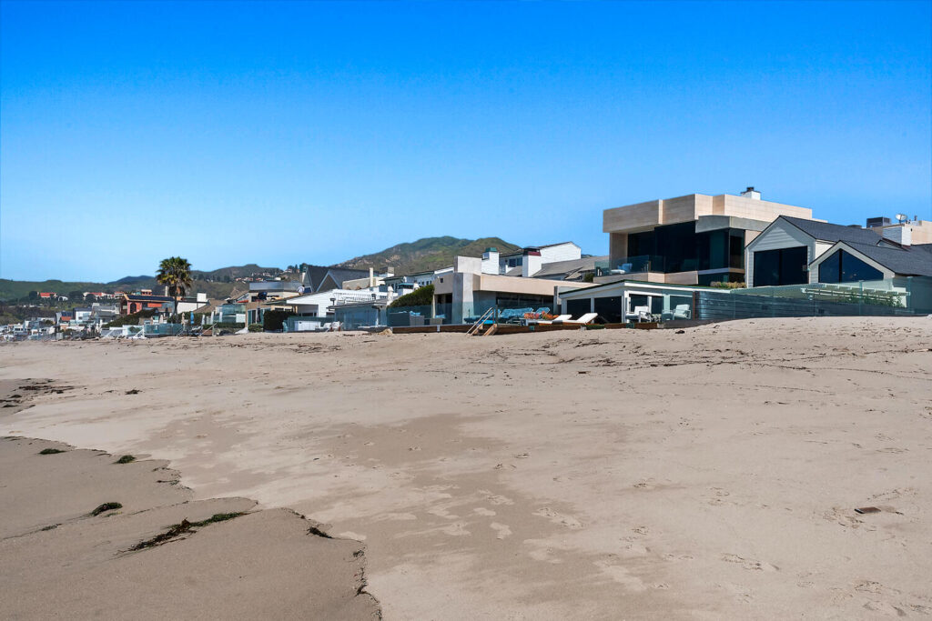 Beachfront homes in the Malibu Colony on a sunny day.