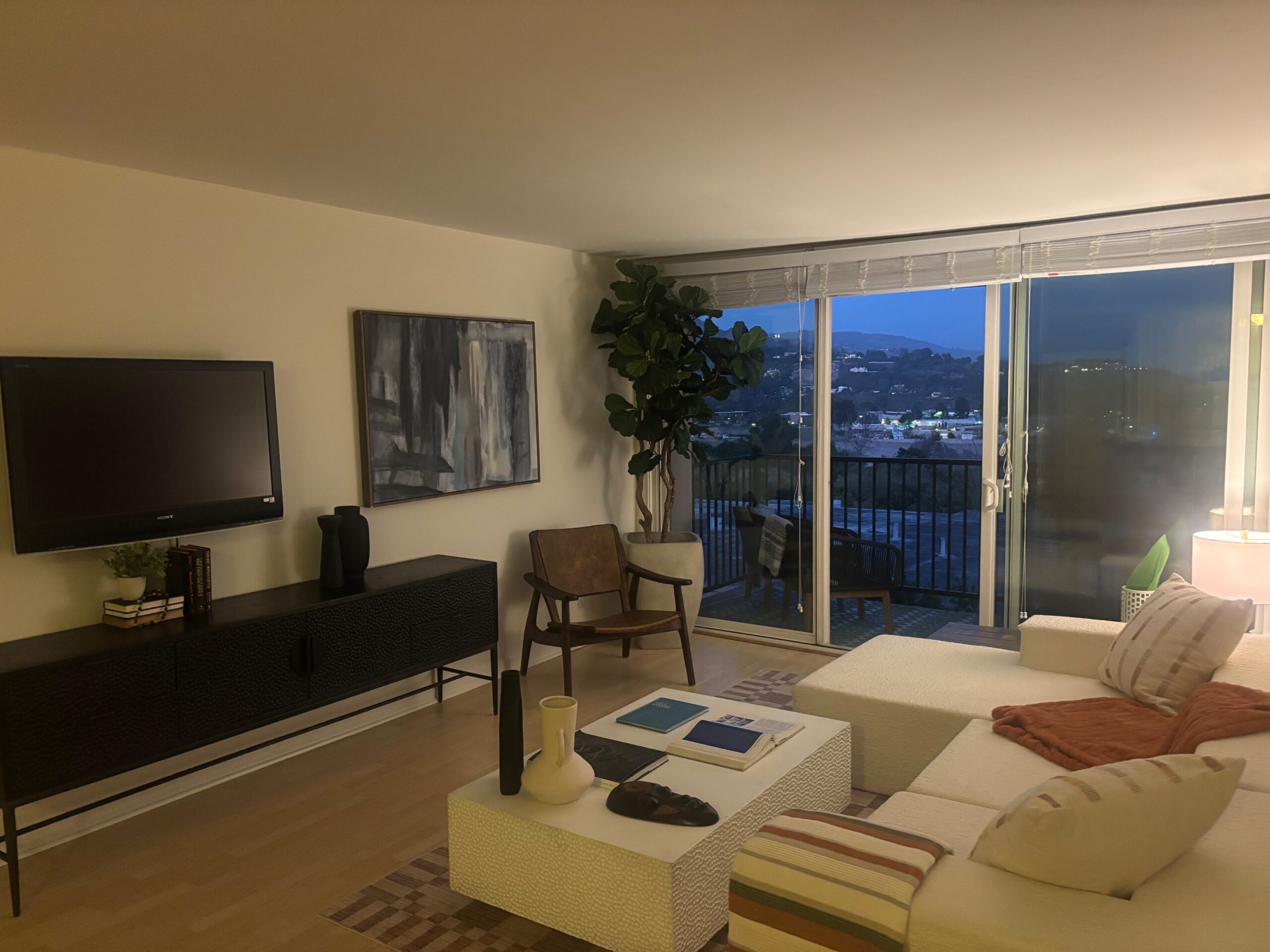 Staged living room with sofa, coffee table and television at 23901 Civic Center Way number 235