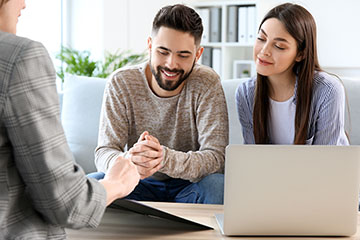 Young couple in office of real estate agent