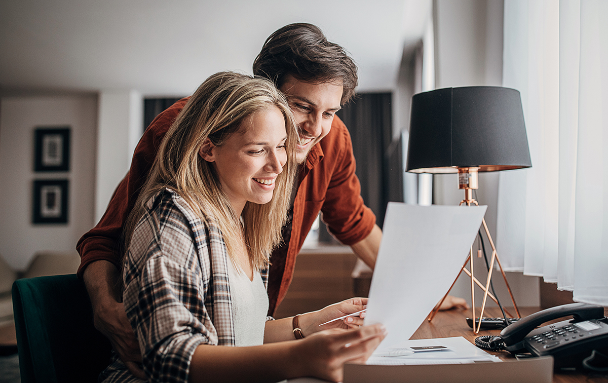 Couple looking at brochures in hotel room