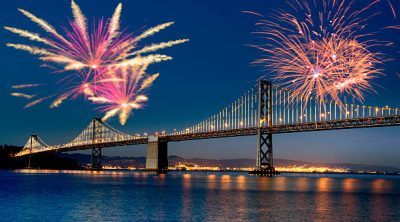 Fireworks over Bay Bridge, San Francisco, California, USA.