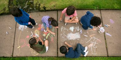 National Good Neighbor Day Featured Image - Kids walk chalk on sidewalk Healthy Community Setting