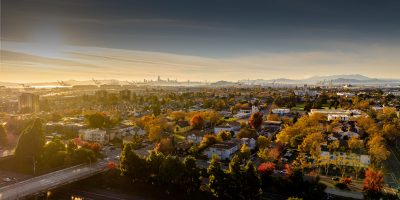Aerial view of Oakland neighborhoods with seasonal landscape, showcasing East Bay homes and real estate market trends.