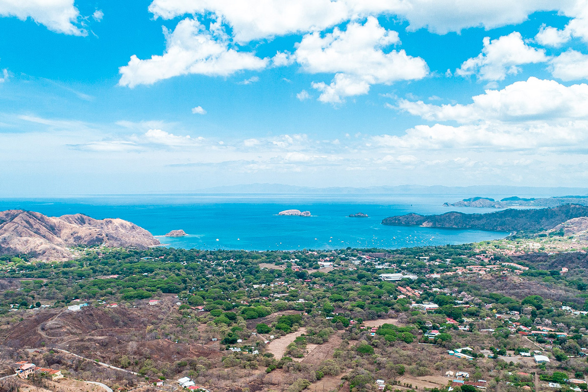 Aerial view of Playas del Coco with the bay, beach, and homes