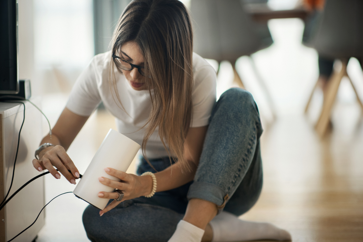 Homeowner installing Wi-Fi router for reliable internet in older home