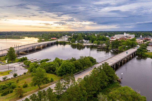 Aerial view of Jacksonville, North Carolina showing the New River, bridges, and surrounding neighborhoods