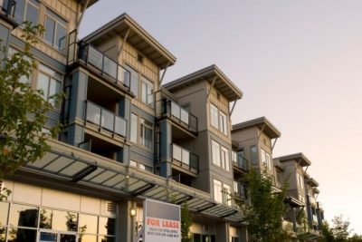 Modern condo building with “For Lease” sign representing growing condo availability in 2025.