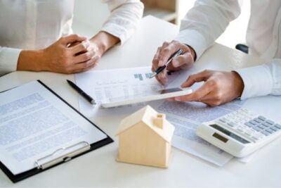Homebuyers reviewing closing cost documents with a real estate agent in the DMV area, including Washington DC, Maryland, and Virginia.