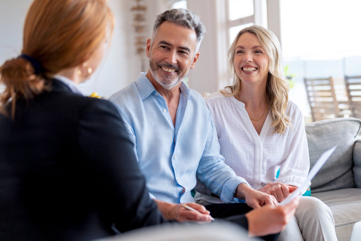 Happy mature couple meeting investments and financial advisor at home