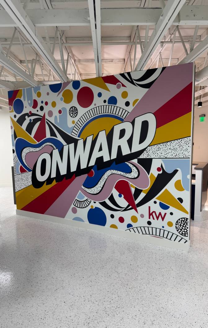 Colorful ONWARD mural in a Keller Williams office interior